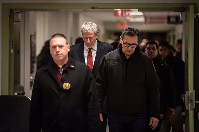 Fire Commissioner Daniel Nigro and Mayor Bill de Blasio head to a press conference about the firefighter's death on Sunday.